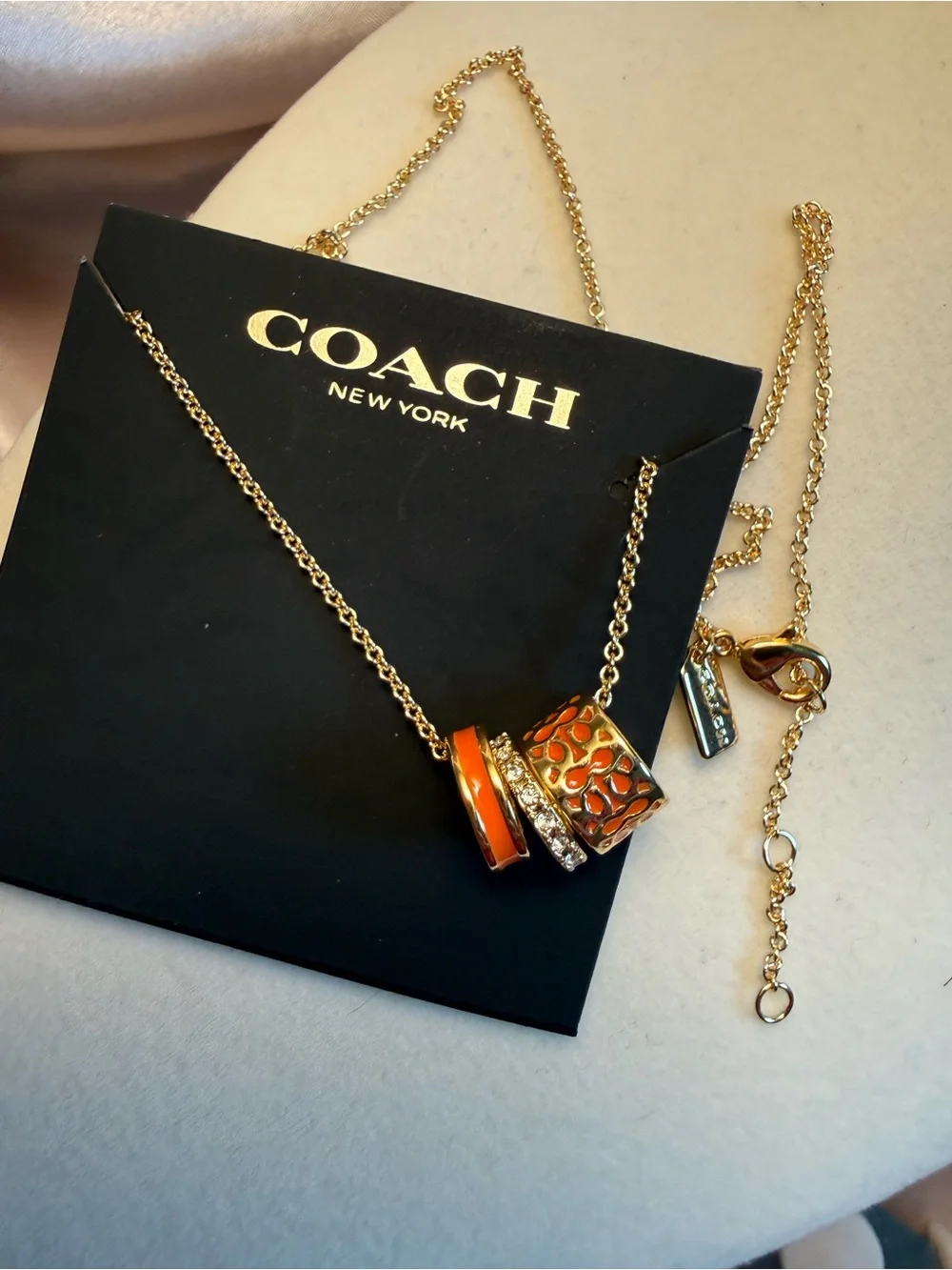 Coach Gold-Tone Necklace with Orange Enamel and Crystal Accents